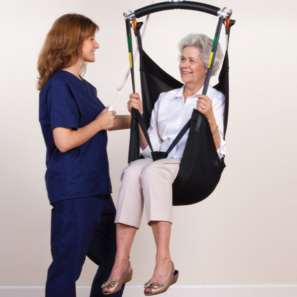comfort care sling in use with nurse handicare 600x600